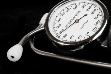Sphygmomanometer and stethoscope on black background