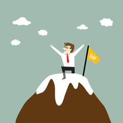 Businessman standing on a peak