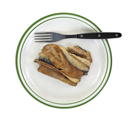 Herring fillets on plate with fork