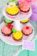 Delicious beautiful  cupcakes on festive table close-up