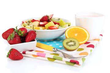 Useful fruit salad of fresh fruits and berries in bowl isolated