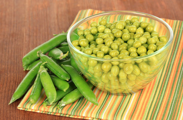 Green peas on wooden background