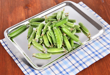 Green peas on napkin on table