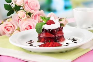 Tasty jelly dessert with fresh berries, on bright background