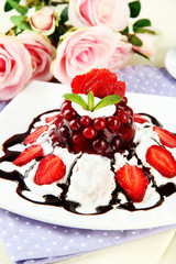 Tasty jelly dessert with fresh berries, on pink roses