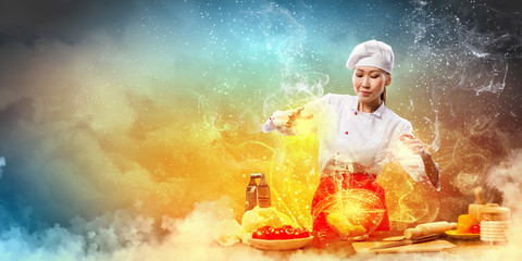 Asian female cooking with magic