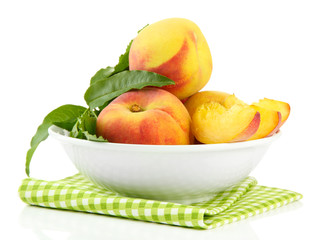 Ripe sweet peaches in bowl, isolated on white