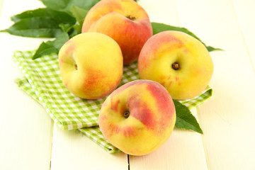 Ripe sweet peaches on wooden table