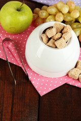 Unrefined sugar in white sugar bowl on wooden background