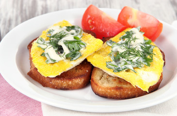 Scrambled eggs and toast on plate close-up