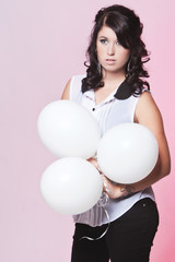 Female model holding three balloons