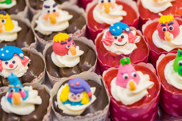 Fototapeta na wymiar many sweet birthday cupcakes with flowers and butter cream