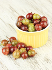 Fresh gooseberries in bowl on table close-up