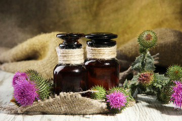 Medicine bottles with thistle flowers