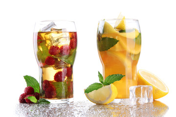 Iced tea with raspberries, lemon and mint isolated on white