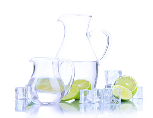 Glass pitchers of water with ice and lime isolated on white