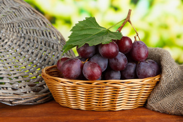 Ripe delicious grapes in wicker basket