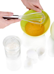Whisking eggs isolated on white