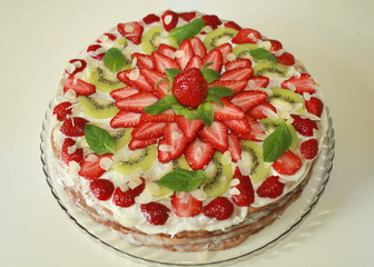 cake with strawberries kiwi and mint green