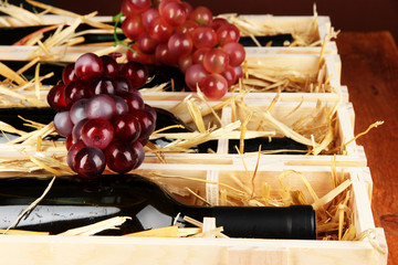 Wooden case with wine bottles close up