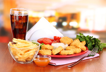Fried chicken nuggets with vegetables,cola,french fries and