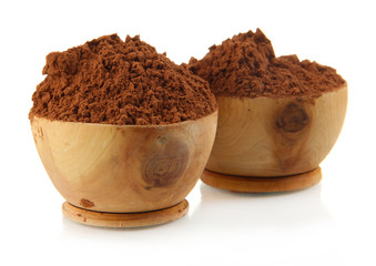 Cocoa powder in wooden bowls, isolated on white