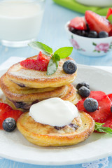 Pancakes with blueberries and strawberries.