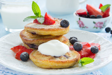 Pancakes with blueberries and strawberries.