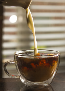Pouring Creamer into a Coffee Cup