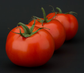Tomato vegetables isolated on black background