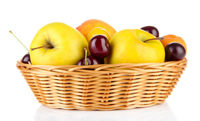 Bright summer fruits in basket isolated on white