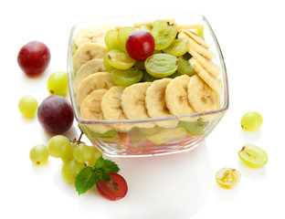 Tasty fruit salad in glass bowl, isolated on white