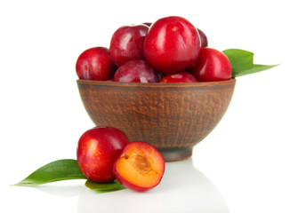 Ripe plums in bowl isolated on white