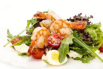 salad greens and shrimp on a white background in the restaurant