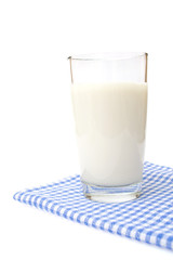 A Glass of milk on plaid towel, isolated on the white.