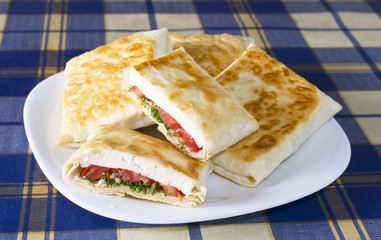 Pita bread with cheese, tomato and herbs
