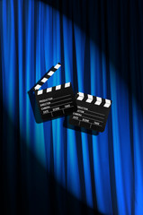 Movie clapper board against curtain