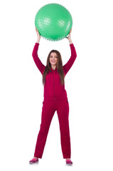 Young woman with ball exercising on white