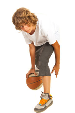 Teenager dribbling basketball