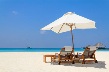Scenery of the beach with a white parasol