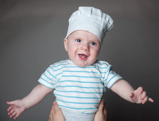 little chef with spoon in hand and hat