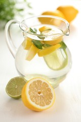 Jug of fresh lemon lemonade with mint leaves