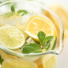 Detail of glass jug with fresh lemonade.