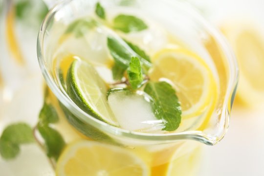 Detail of glass jug with fresh lemonade.