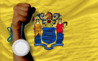 Silver medal for sport and  flag of american state of new jersey