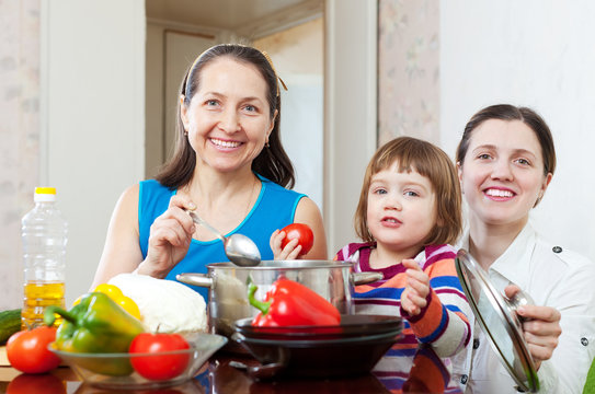  women  with child  cooking veggie lunch