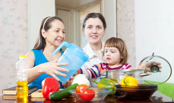 Happy family cook  with vegetables