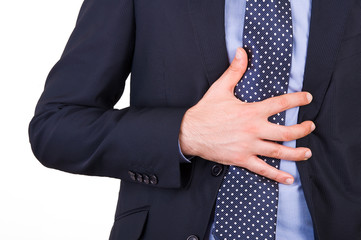 Businessman suffering from heartburn.
