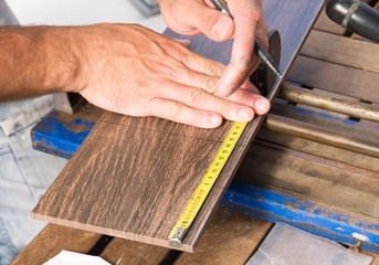 Man measuring a tile piece