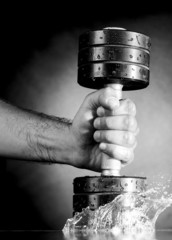 male hand is holding metal barbell